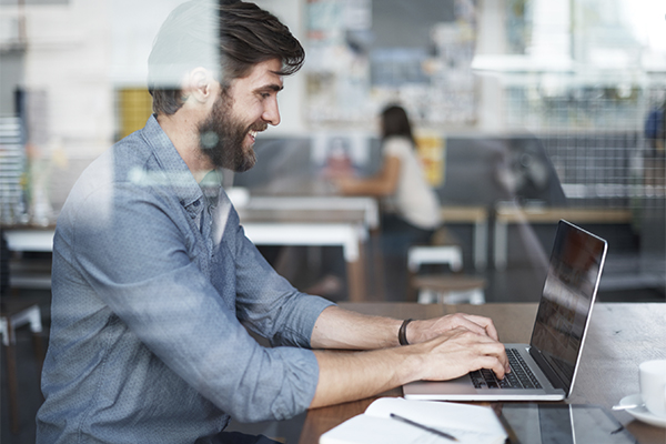 Man working on laptop in a co-working space