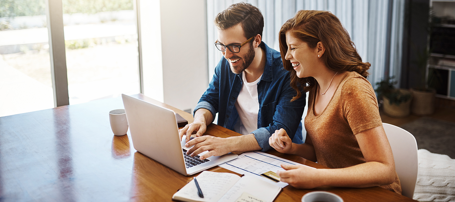 Smiling Couple Banking Online at Home.jpg