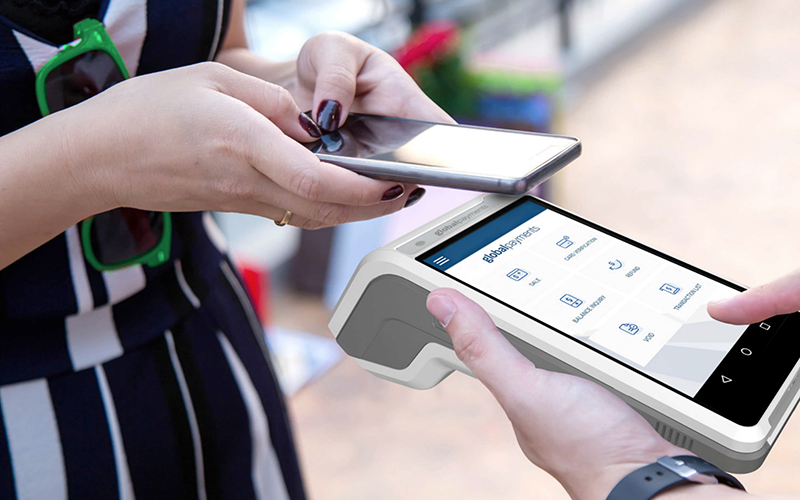 Woman Paying with Global Payments Terminal